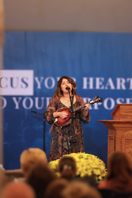 Guest musician singing and playing mandolin